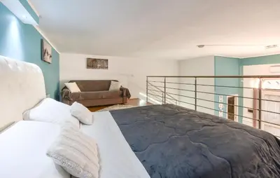 a bedroom with a bed and a couch at Casa Toledo in Partinico