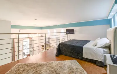 a hotel room with a bed and a balcony at Casa Toledo in Partinico