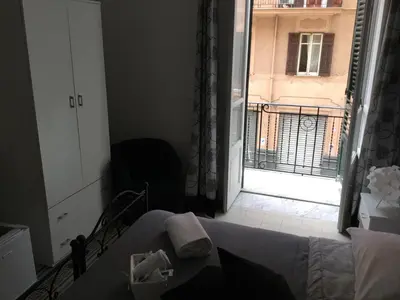 a room with a bed and a view of a building at Alba Camere in Palermo