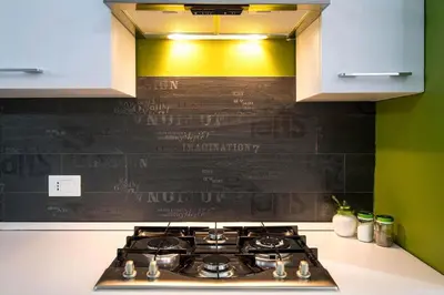 a stove top in a kitchen with a sign on the wall at Quattro Canti Apartments in Palermo