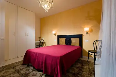 a bedroom with a bed with a red blanket at Via Nuova in Castellammare del Golfo