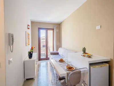 a living room with a white couch and a table at Via Nuova in Castellammare del Golfo