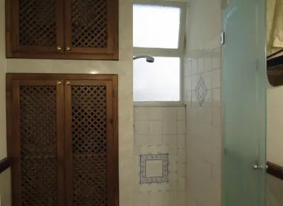 a bathroom with a toilet and a shower with a window at Trilocale al Politeama - Zyz in Palermo