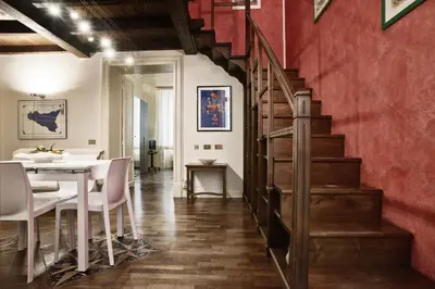 a staircase leading up to a dining room with a table at Trilocale al Politeama - Zyz in Palermo