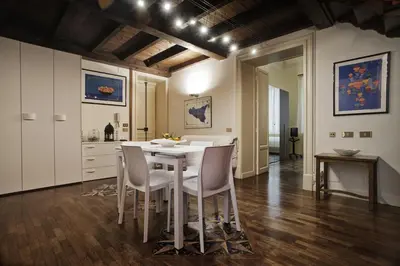 a kitchen and dining room with a table and chairs at Trilocale al Politeama - Zyz in Palermo