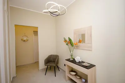 a room with a table and a chair and a vase of flowers at Cala di Ponente in Castelluzzo