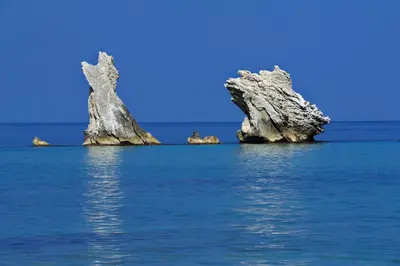 two rocks in the water with a blue sky at Case Vacanze Terra Sinus in Terrasini