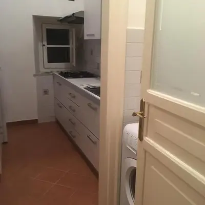 a kitchen with a sink and a stove top oven at I Pupi Di Belfiore in Palermo
