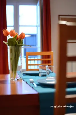 a vase of orange flowers sitting on a table at I Pupi Di Belfiore in Palermo
