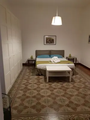 a bedroom with a bed and a rug at I Pupi Di Belfiore in Palermo