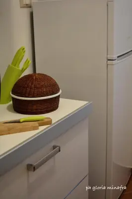 a kitchen counter with a basket and a refrigerator at I Pupi Di Belfiore in Palermo