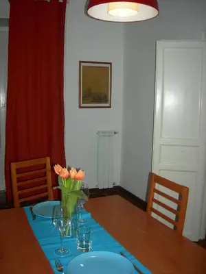 a dining room table with a vase of flowers on it at I Pupi Di Belfiore in Palermo