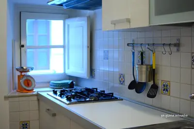 a kitchen counter with a stove and a window at I Pupi Di Belfiore in Palermo