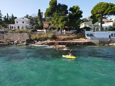 a person on a raft in the water at Villa Agave - SeaFront - Pool Kids - BBQ in Santa Flavia