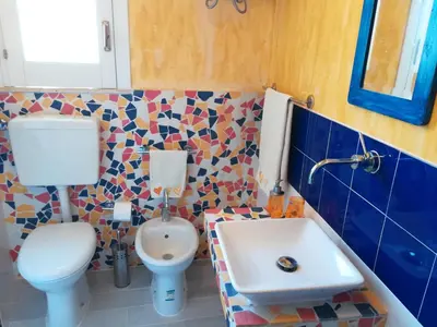 a bathroom with a toilet and a sink at Villetta Degli Oleandri in Castellammare del Golfo