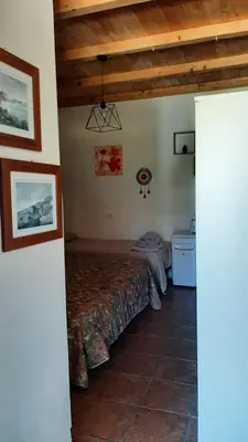 a bedroom with a bed in the corner of a room at Casa Vacanza e Camera Fabiola in Castellammare del Golfo