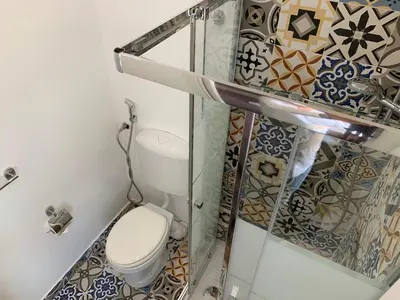 a bathroom with a toilet in a room with tiles at Cialoma B&B in Palermo
