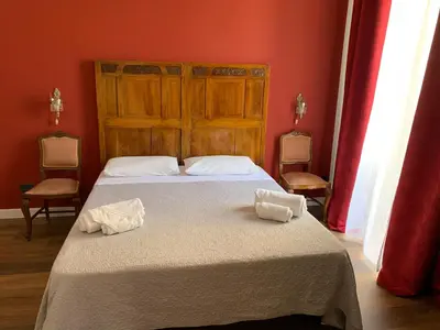 a bedroom with a bed with two towels on it at Cialoma B&B in Palermo