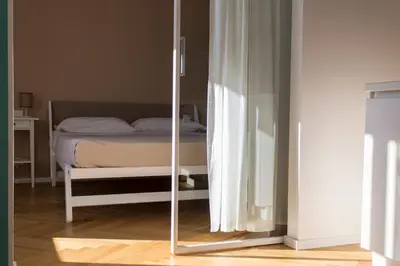 a bedroom with a bed and a mirror on the floor at Residence Itaca in Castellammare del Golfo