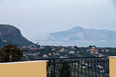 a view of a city with mountains and the ocean at Agriturismo Rajata in Bagheria