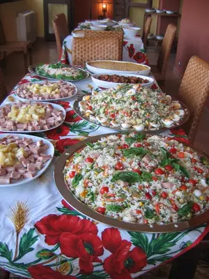 a long table with many plates of pizzas on it at Agriturismo Rajata in Bagheria