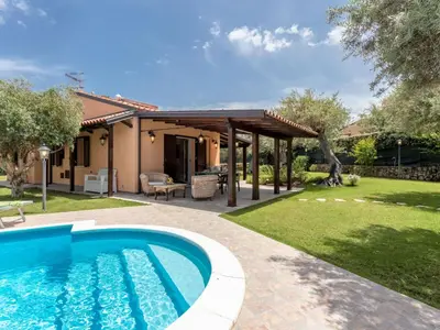 a backyard with a swimming pool and a pergola at Villa Jancaliva by Interhome in Cefalù