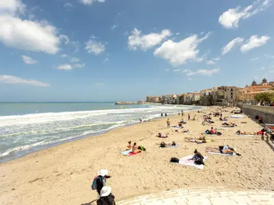 a group of people laying on a beach at Villa Jancaliva by Interhome in Cefalù