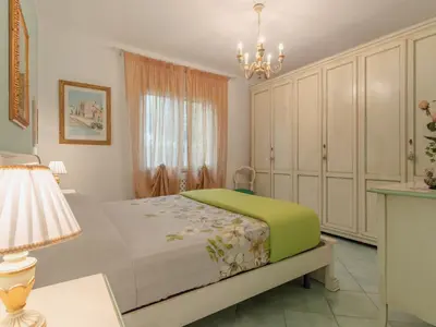 a bedroom with a bed and a chandelier at Villa Jancaliva by Interhome in Cefalù