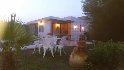 a group of white chairs and a table in a yard at Camera relax riservata intero appartamento in Carini