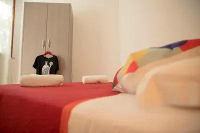 a bedroom with a bed with a dresser and a shirt at Villa Maria in San Vito lo Capo
