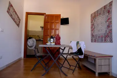 a dining room with a table and two chairs at Villa I Due Pini in San Vito lo Capo