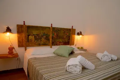 a bedroom with a bed with towels on it at Villa I Due Pini in San Vito lo Capo