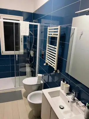 a blue bathroom with a toilet and a sink at Casa Vacanza Mare in Castellammare del Golfo