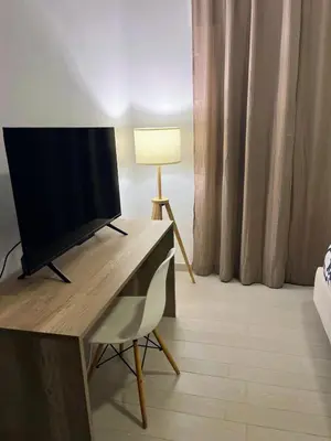 a room with a desk with a television and a lamp at Casa Vacanza Mare in Castellammare del Golfo
