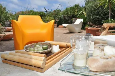 a table with a tray of food and a glass at Villa Il Cappero in San Vito lo Capo