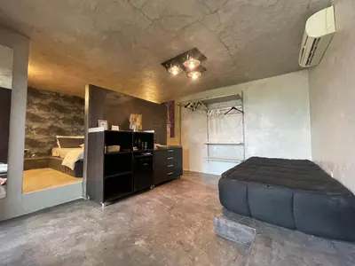 a bedroom with a large bed and a mirror at Villa Il Cappero in San Vito lo Capo