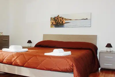 a bedroom with a bed with two hats on it at La Casetta in Palermo