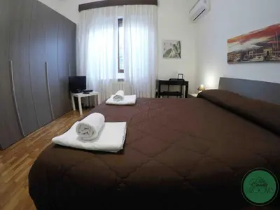 a bedroom with a large bed with towels on it at La Casetta in Palermo