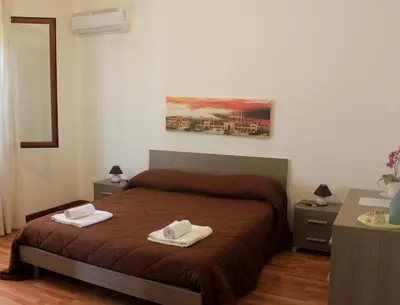 a bedroom with a bed with two towels on it at La Casetta in Palermo