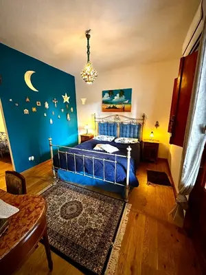a bedroom with a blue bed and a blue wall at Casa Perciata - Locazione Turistica in Mondello