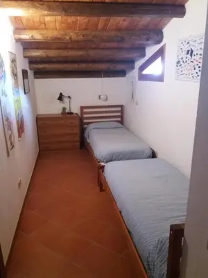 a room with two beds and a wooden ceiling at Casa Vacanze La Terrazza Sul Golfo in Castellammare del Golfo
