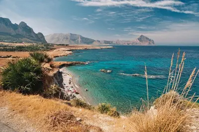 a view of a beach with people in the water at Coralia Bed & Breakfast in San Vito lo Capo