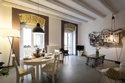 a dining room with a table and chairs at Cassari UpArtments in Palermo
