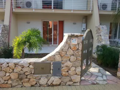 a stone wall with a gate in front of a house at Villa Iris in Castellammare del Golfo