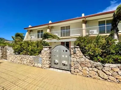 a large house with a stone wall and a door at Villa Iris in Castellammare del Golfo