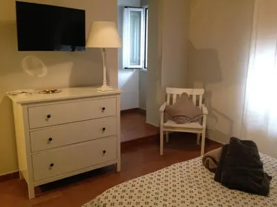 a bedroom with a bed and a dresser with a tv at Baglio San Giovanni in Palermo