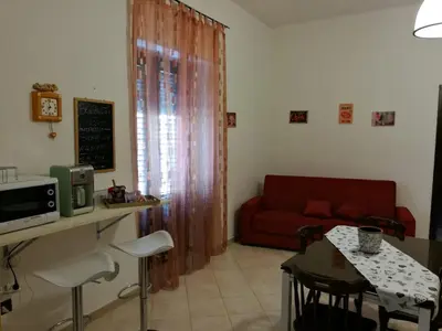 a living room with a red couch and a table at Appartamento Delle Pergole in Palermo