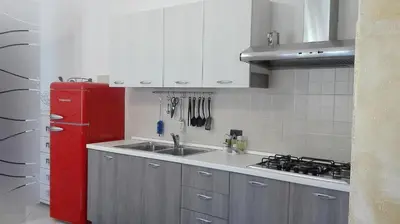 a kitchen with a red refrigerator and a sink at Appartamento Delle Pergole in Palermo