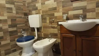 a bathroom with a toilet and a sink at Casolare La Torre in Scopello