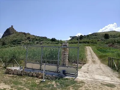 a gate on the side of a dirt road at Casolare La Torre in Scopello